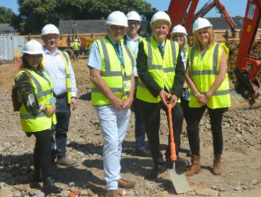 (front right) Cllr Sue Ballard, next to Leader Cllr Peter Chegwyn (front centre) and Cllr Jamie Hutchison (front left), with council housing officers and representatives from PMC Ltd at the Stoners Close site.