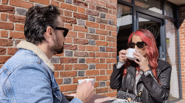 Couple having coffee on a table outdoors